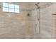 This tiled walk-in shower has a rainfall shower head, handheld shower, and a convenient built-in bench at 24705 83Rd E Ave, Myakka City, FL 34251