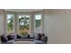 Comfortable sitting area with a built-in bench and windows overlooking the outdoor landscape at 24705 83Rd E Ave, Myakka City, FL 34251