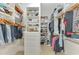 Organized walk-in closet with custom shelving, drawers, and ample hanging space for clothes and accessories at 24705 83Rd E Ave, Myakka City, FL 34251