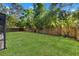 Expansive backyard featuring lush green lawn and privacy fence, perfect for outdoor activities at 2720 Pinewood Ct, Clearwater, FL 33761