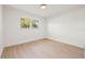 Bedroom featuring light wood-look flooring and a window providing natural light at 2720 Pinewood Ct, Clearwater, FL 33761