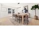 Elegant dining room with large wood table, modern lighting, and stylish decor at 2720 Pinewood Ct, Clearwater, FL 33761