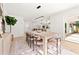 Dining room with long table, stylish chairs, and bright natural lighting at 2720 Pinewood Ct, Clearwater, FL 33761