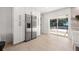 Bright kitchen featuring stainless steel refrigerator and sliding glass doors to the pool at 2720 Pinewood Ct, Clearwater, FL 33761