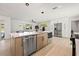 Spacious kitchen island features built-in microwave, sink, and stainless steel dishwasher at 2720 Pinewood Ct, Clearwater, FL 33761