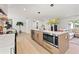 Modern kitchen with large island, stainless appliances, and light wood floors at 2720 Pinewood Ct, Clearwater, FL 33761