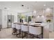 Modern kitchen island with white countertop, four barstools, and stainless steel appliances at 2720 Pinewood Ct, Clearwater, FL 33761