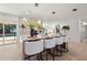 Stylish kitchen island with barstool seating, modern appliances, and a view to the outdoor pool area at 2720 Pinewood Ct, Clearwater, FL 33761