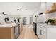 Bright, modern kitchen with stainless steel appliances, island with sink, and white cabinets at 2720 Pinewood Ct, Clearwater, FL 33761