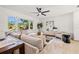 Cozy living room with large sectional sofa, modern fan, and bright windows at 2720 Pinewood Ct, Clearwater, FL 33761
