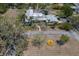 Aerial view of the home, showcasing the backyard pool, circular driveway, and mature trees on an oversized lot at 2723 59Th St, Sarasota, FL 34243