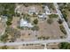 Expansive property featuring a home with a pool, surrounded by mature trees and landscaping on a large lot at 2723 59Th St, Sarasota, FL 34243