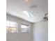 Bright attic with natural light streaming through a skylight and windows, enhancing the ceiling fan at 2723 59Th St, Sarasota, FL 34243