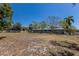 A sprawling backyard is completed with lush grass, landscaping, and privacy fence at 2723 59Th St, Sarasota, FL 34243