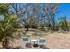 A cozy seating area for relaxing and enjoying the views from the spacious backyard with mature shade trees at 2723 59Th St, Sarasota, FL 34243