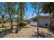 The house's backyard features a screened lanai, landscaping, and privacy fence at 2723 59Th St, Sarasota, FL 34243