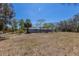 The expansive backyard includes mature trees, a privacy fence, and ample space for outdoor activities and enjoyment at 2723 59Th St, Sarasota, FL 34243
