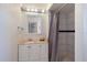 Cozy bathroom features a vanity with marble countertop and a shower with white tiling at 2723 59Th St, Sarasota, FL 34243