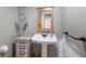 Charming powder room with pedestal sink, custom wood cabinet and decorative mirror at 2723 59Th St, Sarasota, FL 34243