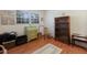Bedroom featuring hardwood floors, a window with blinds, and a mix of vintage-style furniture at 2723 59Th St, Sarasota, FL 34243
