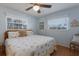 Comfortable bedroom with ceiling fan, hardwood flooring, and ample natural light at 2723 59Th St, Sarasota, FL 34243