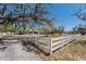 Charming home exterior featuring a manicured front yard and white picket fence, with a circular drive at 2723 59Th St, Sarasota, FL 34243