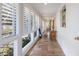 Bright hallway features large windows with shutters, tile flooring, and stylish decor at 2723 59Th St, Sarasota, FL 34243