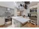Bright kitchen with stainless steel appliances, central island, and ample cabinet space at 2723 59Th St, Sarasota, FL 34243