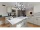 Bright kitchen showcasing white cabinets, a central island with a white countertop, and modern appliances at 2723 59Th St, Sarasota, FL 34243