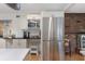 Modern kitchen with stainless steel refrigerator, built-in microwave, and brick accent wall at 2723 59Th St, Sarasota, FL 34243