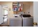Functional laundry room with modern washer and dryer units and ample storage shelving at 2723 59Th St, Sarasota, FL 34243