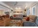 Spacious living room with terracotta floors, ceiling fan, and a view into dining room at 2723 59Th St, Sarasota, FL 34243