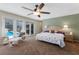 Sun-filled main bedroom boasts a ceiling fan and patio doors that open to the pool area at 2723 59Th St, Sarasota, FL 34243