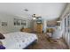 Spacious main bedroom featuring a ceiling fan, light-colored walls, and a cozy sitting area near the windows at 2723 59Th St, Sarasota, FL 34243