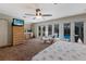 Open main bedroom with workspace, television, and patio doors leading to the pool at 2723 59Th St, Sarasota, FL 34243