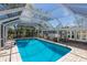 Enclosed pool with outdoor seating offers a relaxing space next to french doors leading inside the home at 2723 59Th St, Sarasota, FL 34243