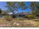 A full view of the back of the home features a beautiful screened in pool and well-maintained landscaping at 2723 59Th St, Sarasota, FL 34243