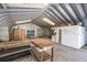 Angled interior view of the metal workshop with a skylight and exposed beams and concrete flooring at 2723 59Th St, Sarasota, FL 34243