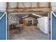 Interior view of the metal workshop showing the open doors and exposed beams at 2723 59Th St, Sarasota, FL 34243