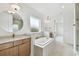 Bright bathroom featuring dual sinks, a soaking tub and modern finishes at 3113 W Nassau St, Tampa, FL 33607