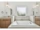 Bright bathroom featuring dual sinks, a soaking tub and pendant lighting at 3113 W Nassau St, Tampa, FL 33607