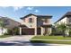 Charming two-story home featuring a two-car garage, stucco finish, and well-manicured lawn at 3113 W Nassau St, Tampa, FL 33607