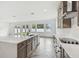 Bright kitchen with stainless appliances, herringbone floors, and an island with quartz countertops at 3113 W Nassau St, Tampa, FL 33607