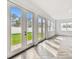 Living room with herringbone floors, access to the backyard, and ample natural light at 3113 W Nassau St, Tampa, FL 33607