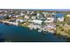 Scenic aerial view of a waterfront home with a private dock, nestled among winding waterways and lush landscapes at 3416 Crape Myrtle Dr, Hernando Beach, FL 34607