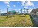 Expansive backyard featuring a grassy area, mature palm trees, and convenient canal access at 3416 Crape Myrtle Dr, Hernando Beach, FL 34607