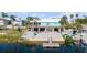 Waterfront backyard with a private dock, patio, and lush landscaping; perfect for enjoying the outdoors at 3416 Crape Myrtle Dr, Hernando Beach, FL 34607