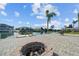 Gorgeous waterfront backyard boasts a fire pit, mature landscaping, and scenic water views at 3416 Crape Myrtle Dr, Hernando Beach, FL 34607