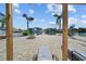 Waterfront backyard features a fire pit, lush palm trees, and a relaxing waterfront view at 3416 Crape Myrtle Dr, Hernando Beach, FL 34607