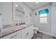 Stylish bathroom featuring a vanity with marbled countertop and white cabinets at 3416 Crape Myrtle Dr, Hernando Beach, FL 34607